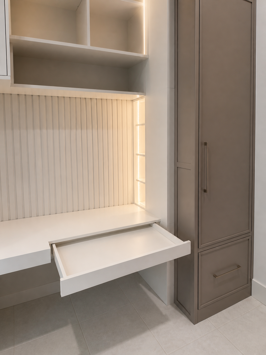 Integrated shallow drawer beneath a custom mudroom desk