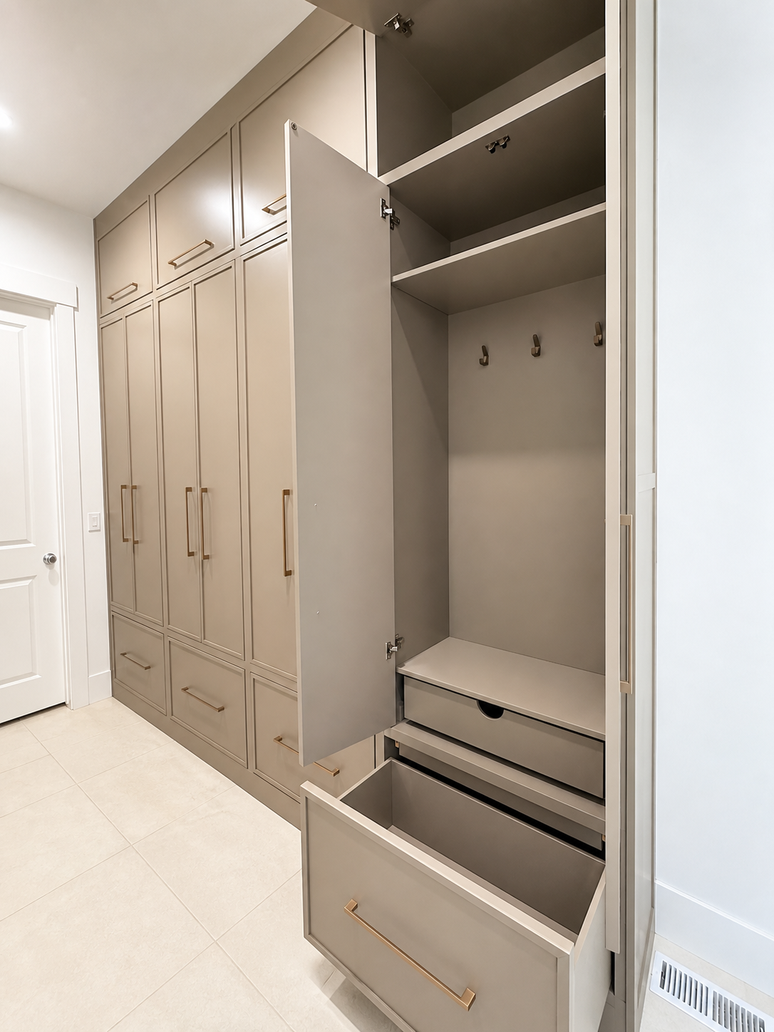 Open custom mudroom locker with upper storage, coat hooks, and deep shoe drawer